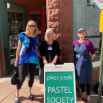 Betsy Cook and Kris Olson with our sidewalk sign